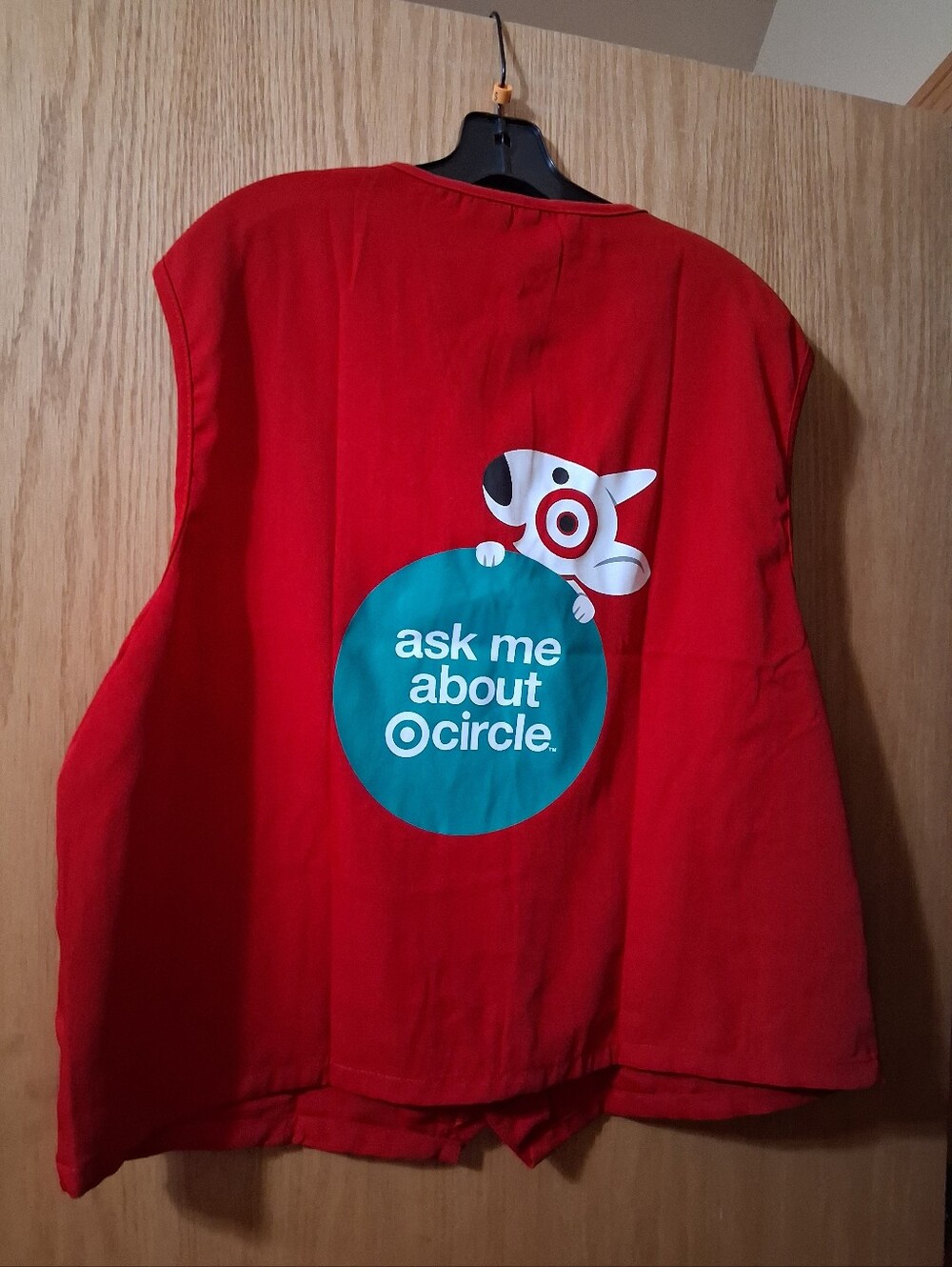 Target employee uniform vest, red button-up work garment, "ask me about Circle"